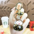 Roze cartoon beer sleutelhanger met gouden glittersterren en pop in een glazen bol - Fleskalebasvorm / Zwart & Goud