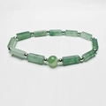 Macro shot of rectangular green natural stone beads and silver spiral bead on bracelet - Green Aventurine