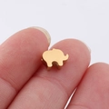 Close-up of a small golden elephant spacer bead held between fingers for jewelry making - 6*8mm Elephant Small Hole Bead / 18K Gold