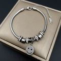 Detailed macro of silver snake chain bracelet with sparkling beads and a smiley face charm - Smile Style (WG1-0357)