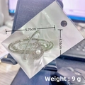 Silver star brooch with sparkling rhinestones and a central pearl, measuring 5.75cm by 4.16cm - Silver Planet