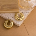 Polished gold croissant hoop earrings with textured finish on stone background - Segmented Texture (ZHE965)