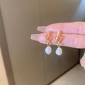 Gold twisted knot earrings featuring elegant white baroque pearl drop pendants - White Freshwater Pearl