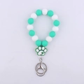 Silicone beaded keychain with white and teal beads featuring a cute paw print charm - Green