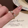 Light luxury gold alloy ring with sky blue and dark coffee enamel chain link details - No Diamond Donut Ring