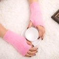 Close-up of pink knitted fingerless gloves showing thick woolen texture and warmth - One Size / Pink