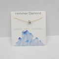 Irregular natural Herkimer Diamond pendant on thin gold chain with white display card - Herkimer Diamond