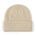 Macro view of a soft beige knitted baby beanie featuring detailed ribbing texture - Beige