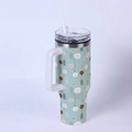 Detail of 40oz stainless steel tumbler featuring mint green floral daisy print and handle - Fresh Daisy/Mint Green