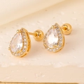 Macro shot of gold pear-shaped stud earrings with clear zircon and screw back - Pear Shape Teardrop