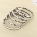 Macro view of 5-piece set high-polished 6mm silver stainless steel bangles - Steel Color 5-Piece Set