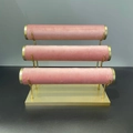 Three-tier jewelry display stand with pink velvet cylinders and golden metal frame - 3-Tier Bracelet Stand / Pink