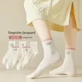 Women's cream white crew socks with jacquard knit patterns and bow details - One Size / Pink Cameo