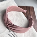 Detailed view of dust pink satin headband featuring a chic twisted knot and elegant luster - Pink