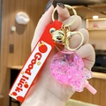 Luminous lollipop keychain with pink glitter sand, red silicone strap and gold bell - Noctilucent Bubble Bead Lollipop-Red