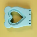 Light blue silicone sandwich cutter mold with a heart-shaped cutout on yellow background - Heart Blue