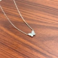 Elegant silver butterfly pendant necklace with mother of pearl inlay on wood surface - Silver