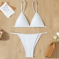 Two-piece white spaghetti strap bikini set with textured fabric on wooden background - L / White