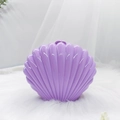 Detailed view of a purple shell-shaped jewelry box on a white faux fur surface - Purple