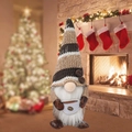 Coffee gnome plush with striped knit hat and cup, warm Christmas fireplace background - Knitted Hat Striped Gnome