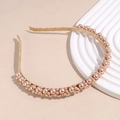 Detailed close-up of an elegant pearl headband with mixed size beads on a satin base - Champagne