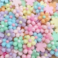 Macro shot of colorful mini macaron resin flower charms for DIY nail art and crafts - Line Floral