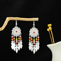 Silver Bohemian tassel earrings with colorful beads and leaf charms on a branch - Colorful