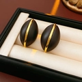 Close-up of black and gold striped oval earrings resting in a premium jewelry display box - Black & Gold (925 Sterling Silver Earring Post)