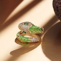 Detailed close-up of a snake-shaped ring with green enamel scales and cubic zirconia - Grass Green