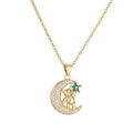 Detailed close-up of a gold crescent moon pendant with a cute bear and green star jewel - Green