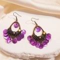 Detail of bohemian purple shell earrings with bronze metal frame on stone surface - Ear Hook-Purple