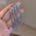 Detail of silver tassel earrings with multiple metal chains held by hand for luxury style - Silver Pointed Cross Tassel