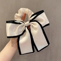 Elegant large cream satin bow hair tie with black trim for low ponytail hairstyles - Black Edge / Beige
