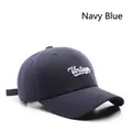 Detailed close-up of navy blue twill cotton baseball cap with white Vintage embroidery - Navy Blue