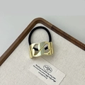 Hair tie with gold chain link ornament and black elastic band on linen tray - Gold Large Chain Smooth