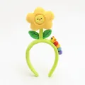 Cute green plush headband with a smiling sunflower and colorful caterpillar design - Sunflower Yellow