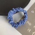 Blue polka dot scrunchie fabric hair tie displayed on a stylish flat lay decorative plate - Sky Blue Polka Dot