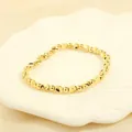 Detail of irregular gold beaded stretch bracelet on a white shell decorative tray - BR1683-J/Gold Irregular Faceted Beads