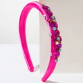 Detail of hot pink satin headband with sparkling colorful rhinestones on a white stand - Rose Red