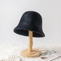 Chic black plush bucket hat for women on a wooden stand with a soft fur rug backdrop - M (56-58cm) / Black