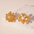 Detailed macro view of gold matte flower clip-on earrings with central white pearl inlay - Gold Flower White Pearl (Silver Pin)