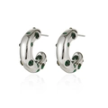 Detail of silver C-shape earrings with green zircon inlays and polished finish - Silver/Green Zirconia