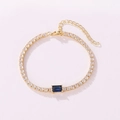 Detailed view of a gold tennis bracelet with clear zircons and a central rectangular blue stone. - Rectangular Style (Blue Rhinestone) / Gold