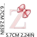 Pink embroidered letter Z patch with red bow detail and size measurements shown - Bow Alphabet Letter Z