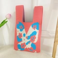 Pink knit tote bag with large butterfly pattern and blue floral details - Butterfly Rose Pink