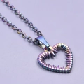 Macro shot of a rainbow stainless steel hollow heart necklace with textured finish detail - Pendant with Necklace / Rainbow