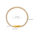 Detailed close-up of a gold titanium steel bracelet set with bright white zircon stones - Gold with White Zircon (E330)