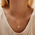 Minimalist gold necklace with zircon flower pendant shown on a model's collarbone - KN0446-Five Petal Flower Rhinestone