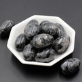 Polished grey and black spotted natural agate egg stones in a white hexagonal bowl - Black Flash Stone (1pc)