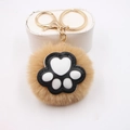 Detail of a fluffy beige cat paw keychain with soft faux fur and gold metal clasp - Cat Claw Gold Keychain / Khaki
